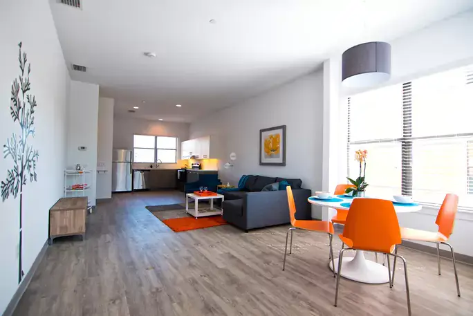 Modern open-plan living room with kitchen and dining area.