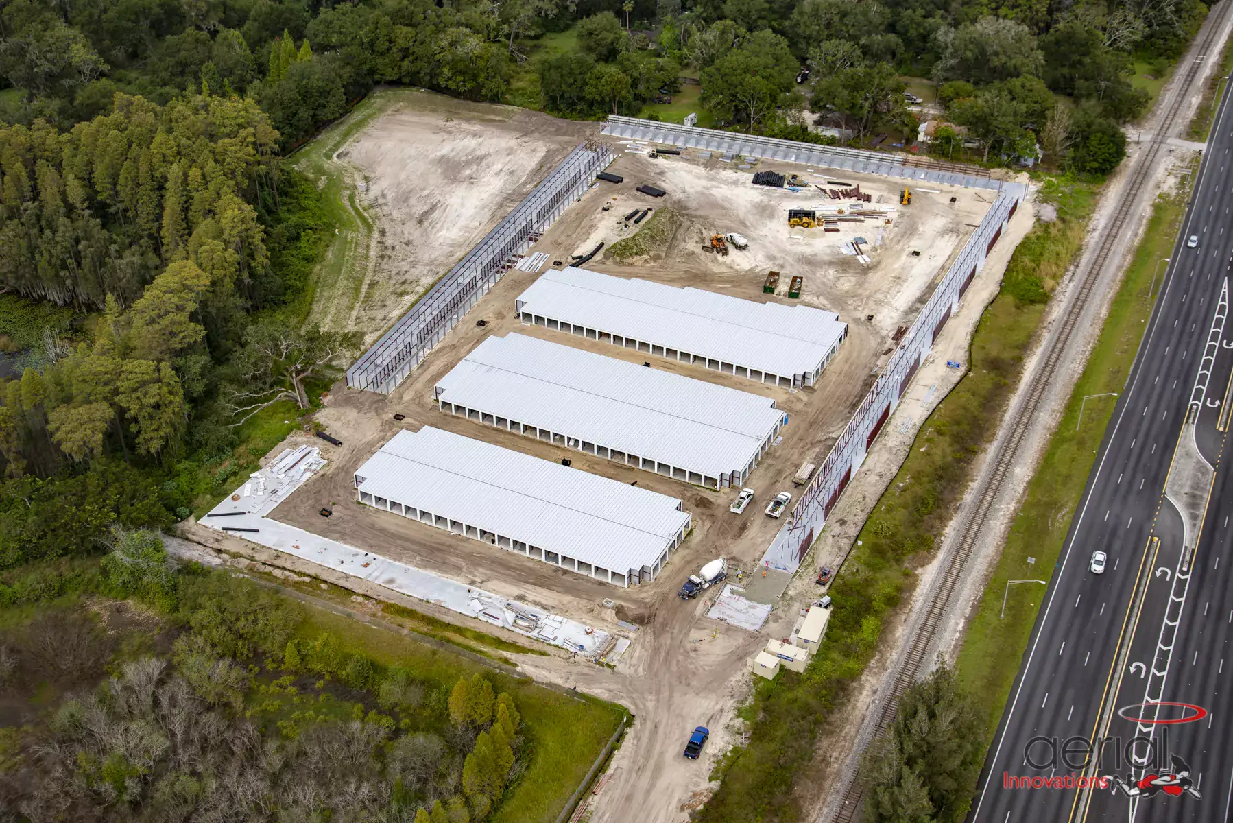 Aerial view of construction site beside highway.